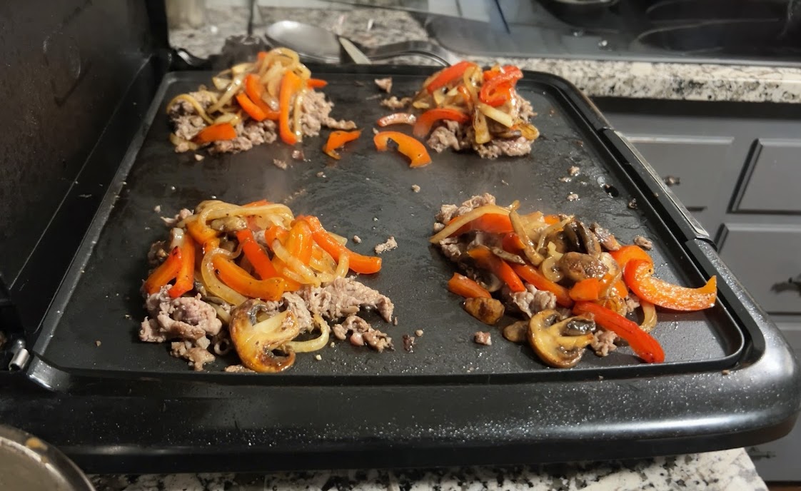 Vegetables added on top of each steak pile